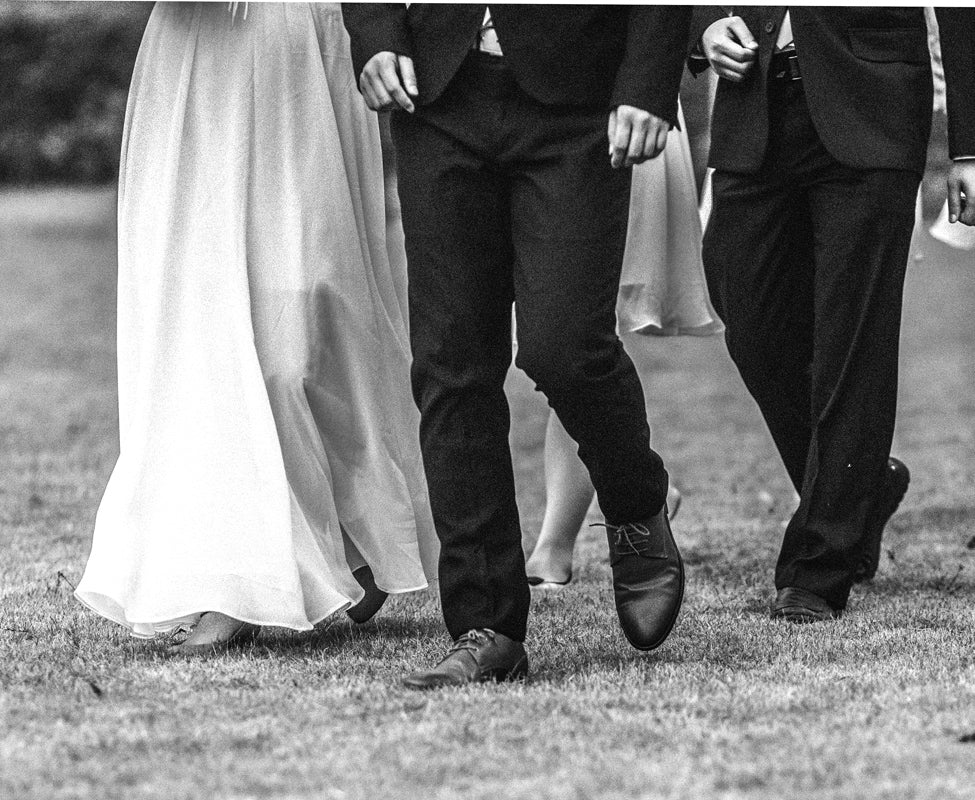 Wedding couple walking on a lawn