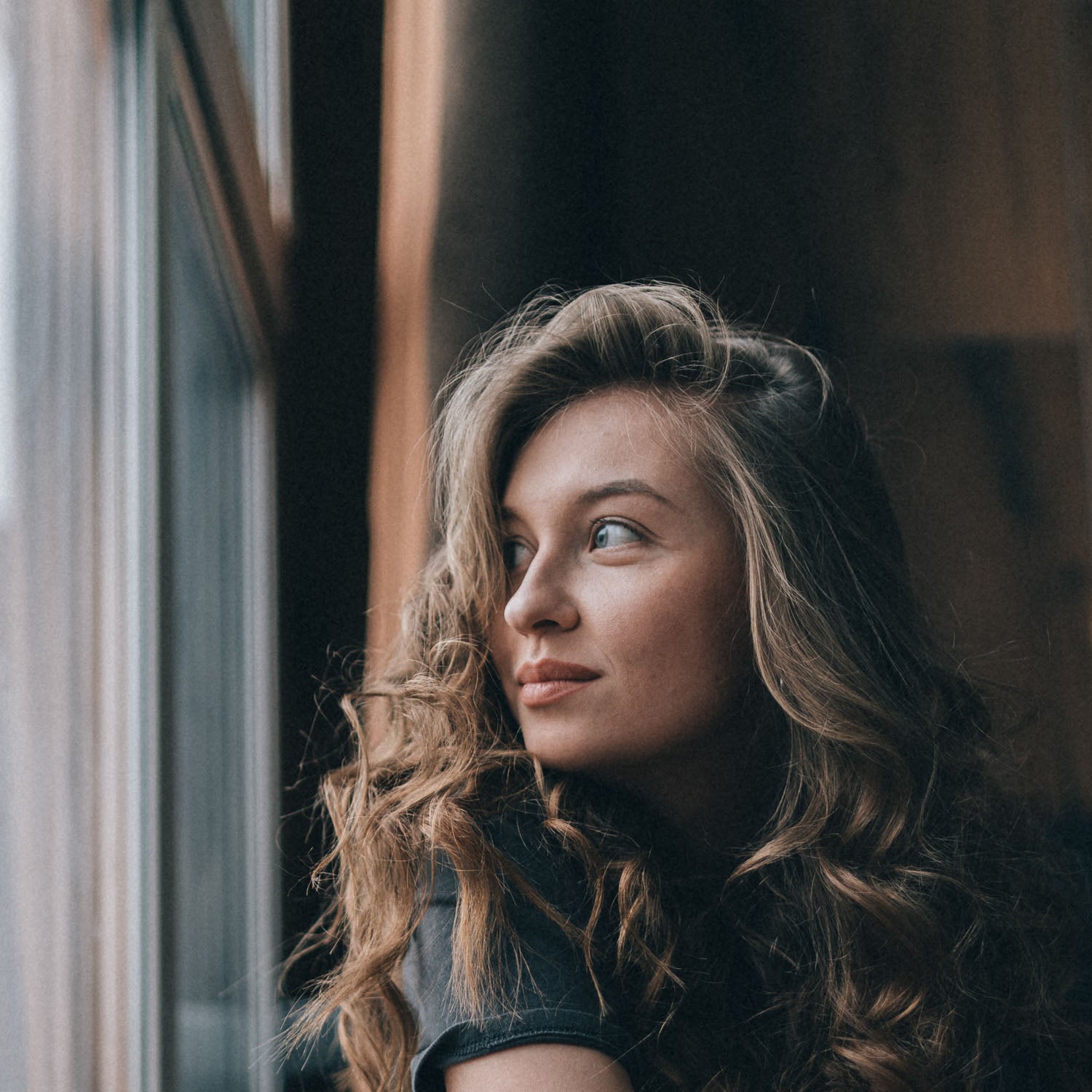 Young lady gazing out a window